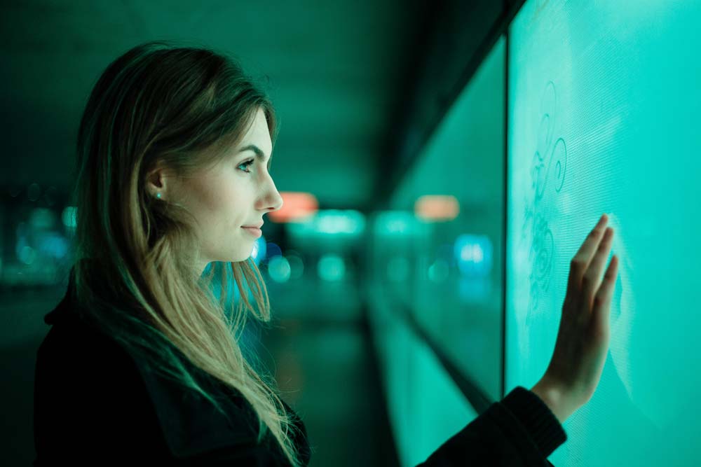 Woman beside a touchscreen